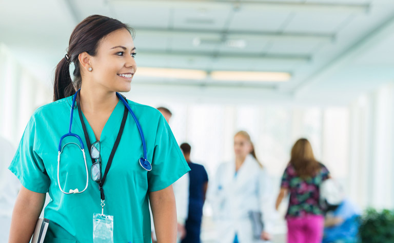 A woman wearing scrubs in a hospital