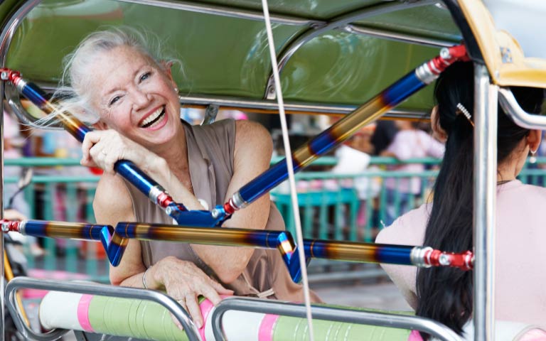 A woman smiling from the back of a vehicle