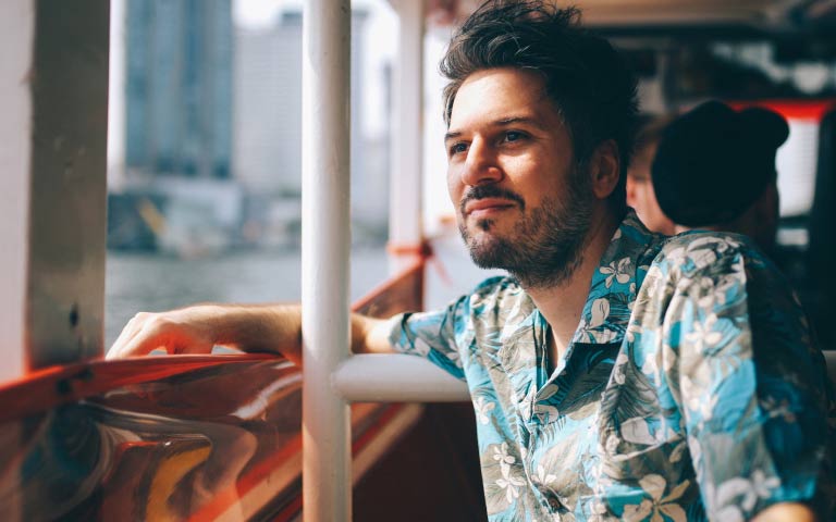 A traveller looking out the window of a bus