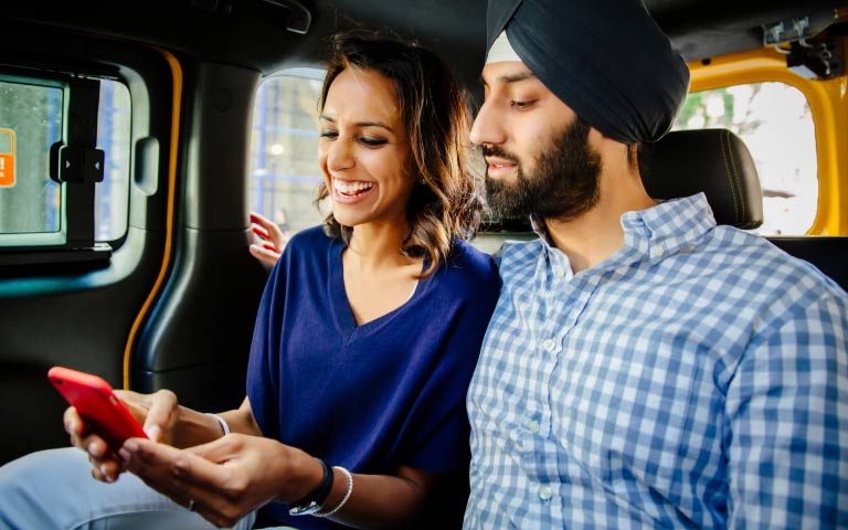 Two people looking at a phone